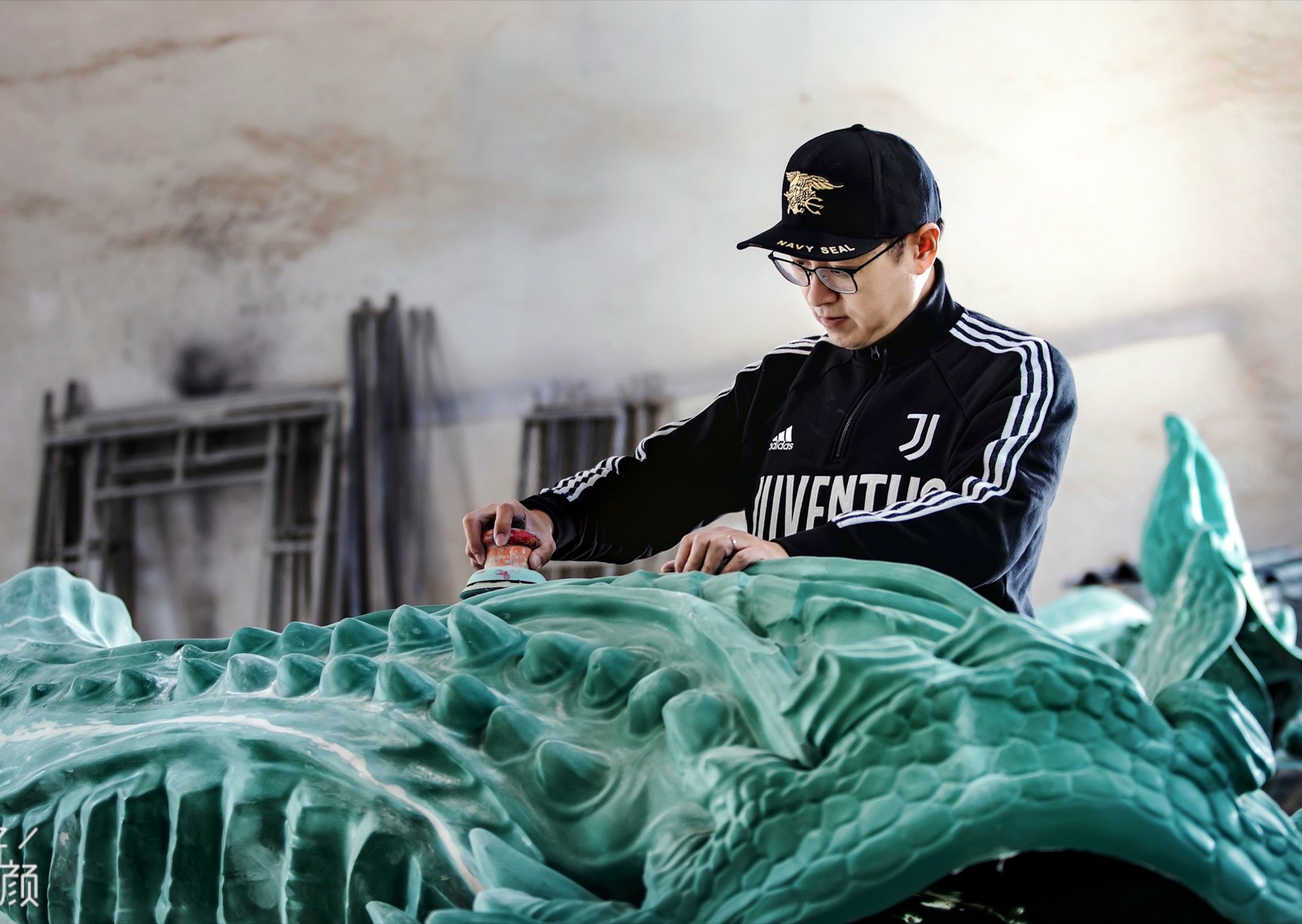 Master X working on a sculpture